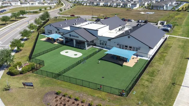 an aerial view of multiple houses with yard