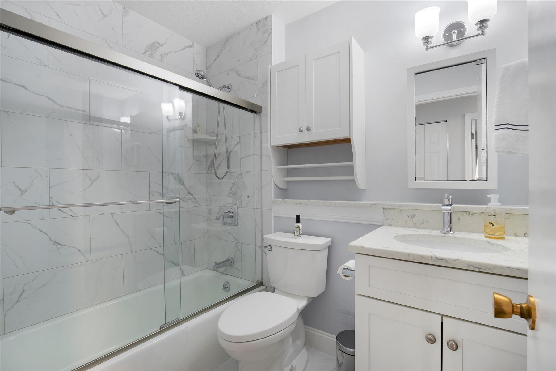 800 Bearses Way, Unit 1EB Hyannis, MA 02601 - Photo 18 of 37 a bathroom with a sink a toilet and shower