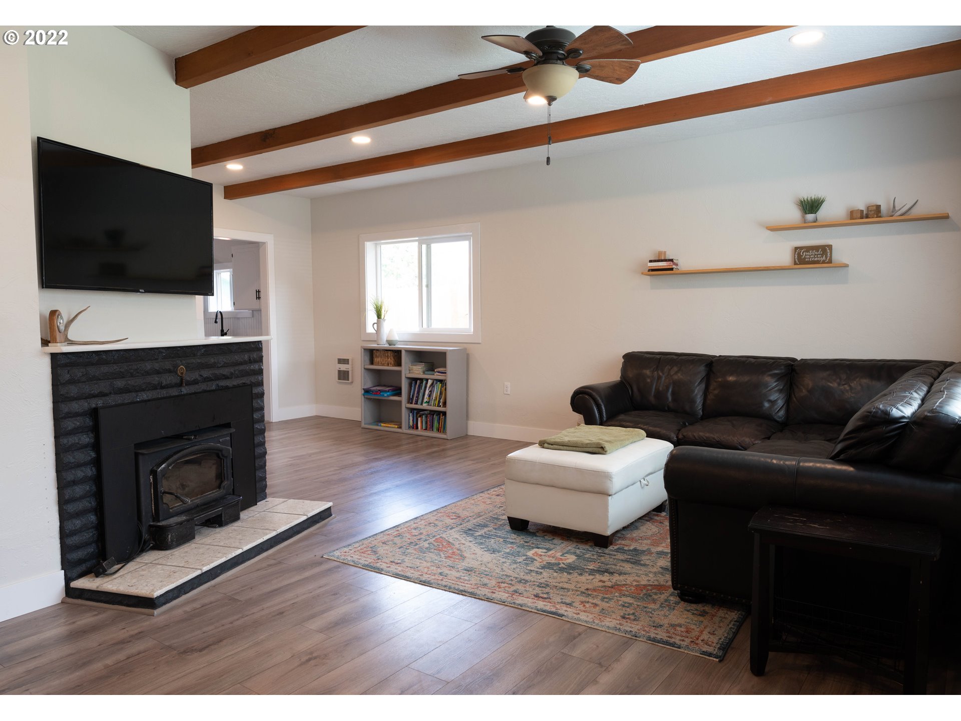 36227 Enterprise Road Creswell, OR 97426 - Photo 6 of 32 a living room with furniture a flat screen tv and a fireplace