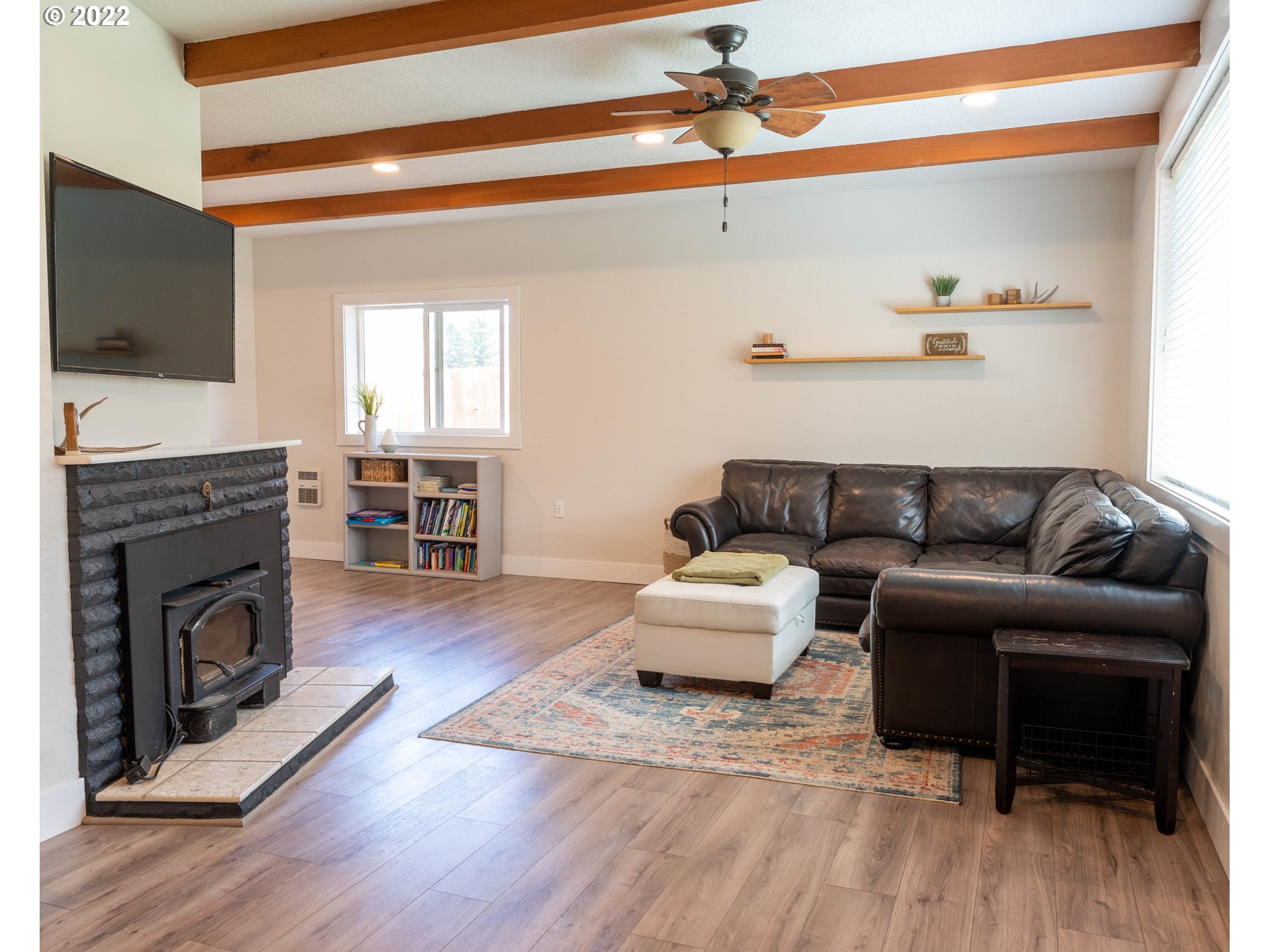 36227 Enterprise Road Creswell, OR 97426 - Photo 7 of 32 a living room with furniture a flat screen tv and a fireplace