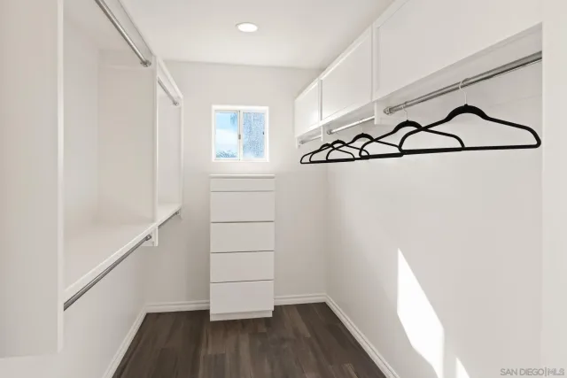 a view of a dining room with furniture a chandelier and wooden floor