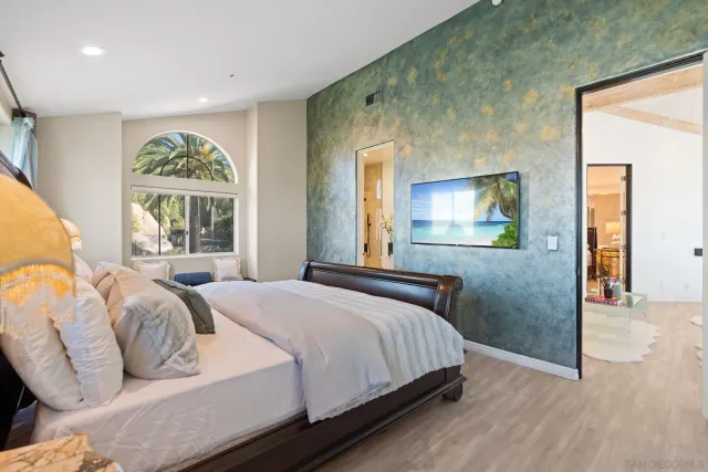 a bathroom with a granite countertop sink a toilet a mirror a bathtub and shower