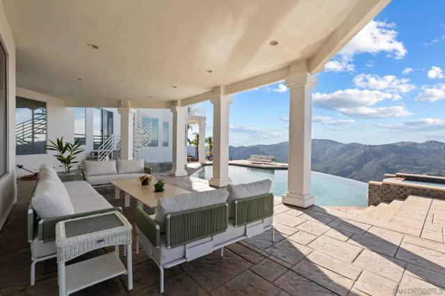 a living room with fireplace furniture and a large window
