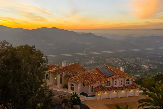 a front view of a house with a yard and balcony