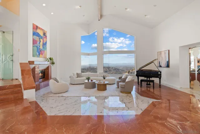 a living room with furniture a rug and a large window