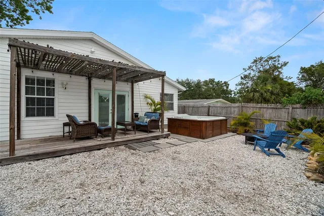 a view of a house with backyard and sitting area