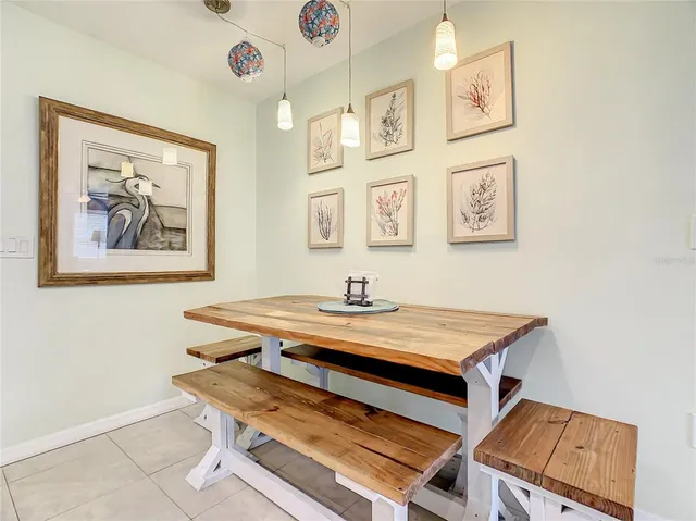 a room with stainless steel appliances kitchen island granite countertop a sink a stove and a refrigerator