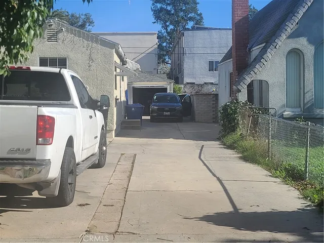 a view of a patio with table and chairs potted plants