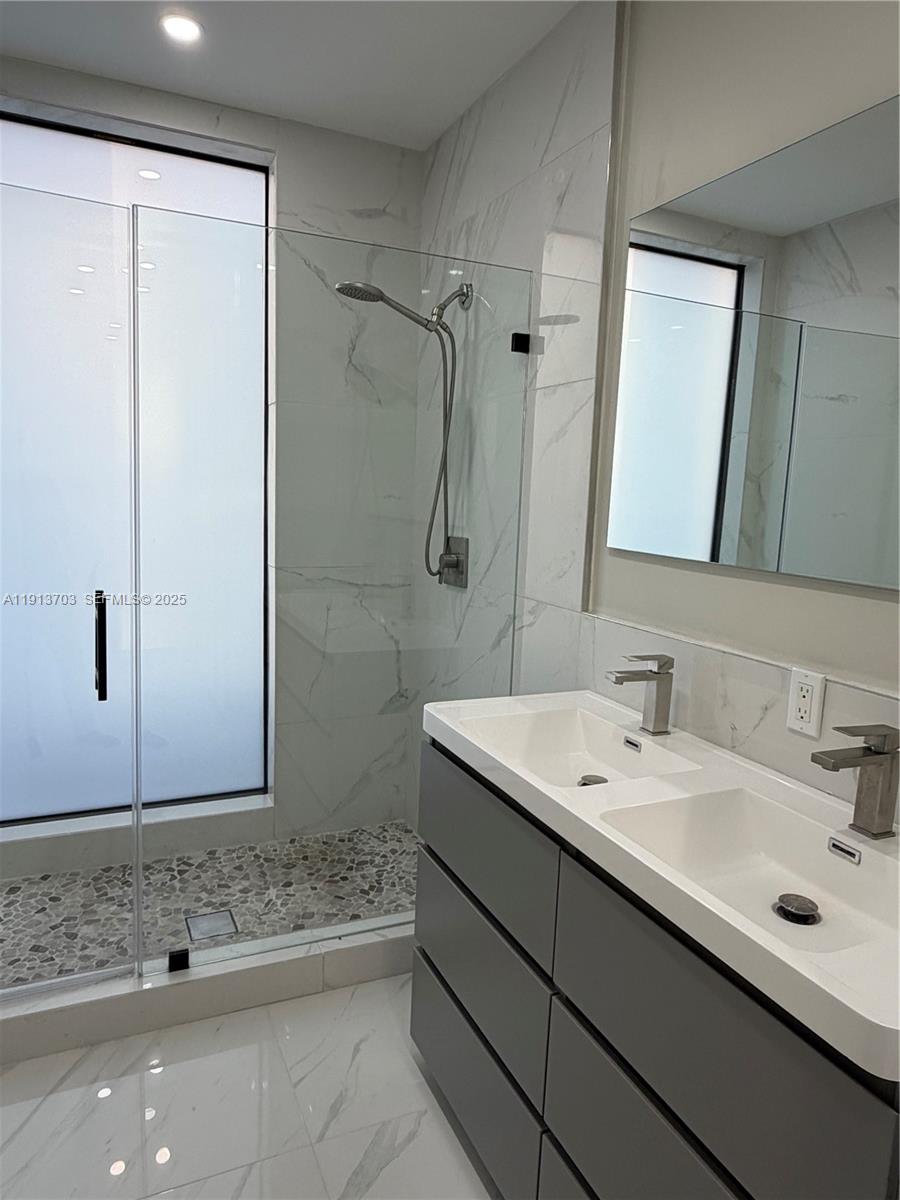 570 Fernwood Road Key Biscayne, FL 33149 - Photo 13 of 18 a bathroom with a sink and a mirror