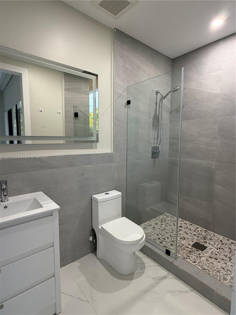 570 Fernwood Road Key Biscayne, FL 33149 - Photo 15 of 18 a bathroom with a toilet sink and shower