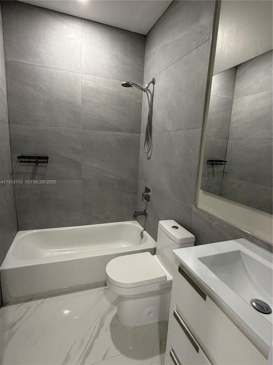 570 Fernwood Road Key Biscayne, FL 33149 - Photo 17 of 18 a bathroom with a toilet and a sink