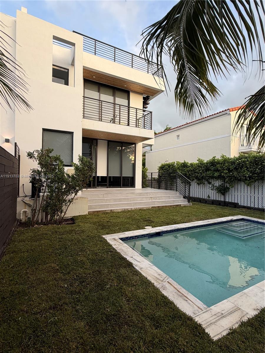 570 Fernwood Road Key Biscayne, FL 33149 - Photo 6 of 18 a view of a house with a swimming pool