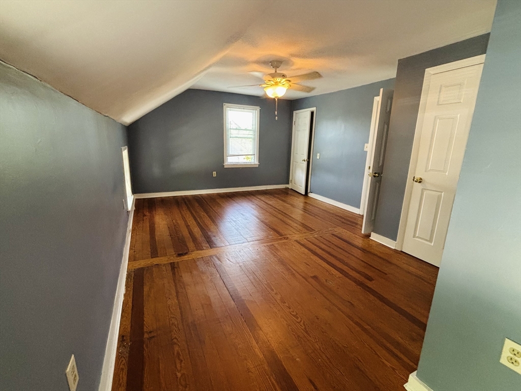 27 Fletcher Street, Unit 1 Northbridge, MA 01588 - Photo 12 of 12 a view of an empty room with wooden floor and a window