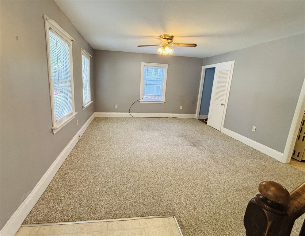 27 Fletcher Street, Unit 1 Northbridge, MA 01588 - Photo 4 of 12 a view of an empty room with a window