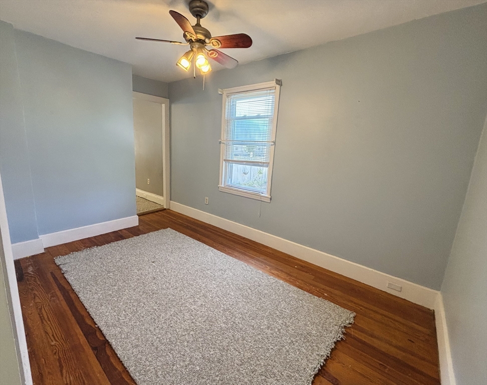 27 Fletcher Street, Unit 1 Northbridge, MA 01588 - Photo 5 of 12 an empty room with windows