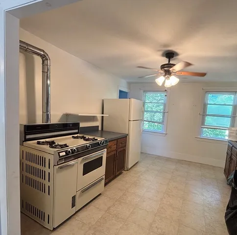a kitchen with stainless steel appliances granite countertop a stove and a refrigerator
