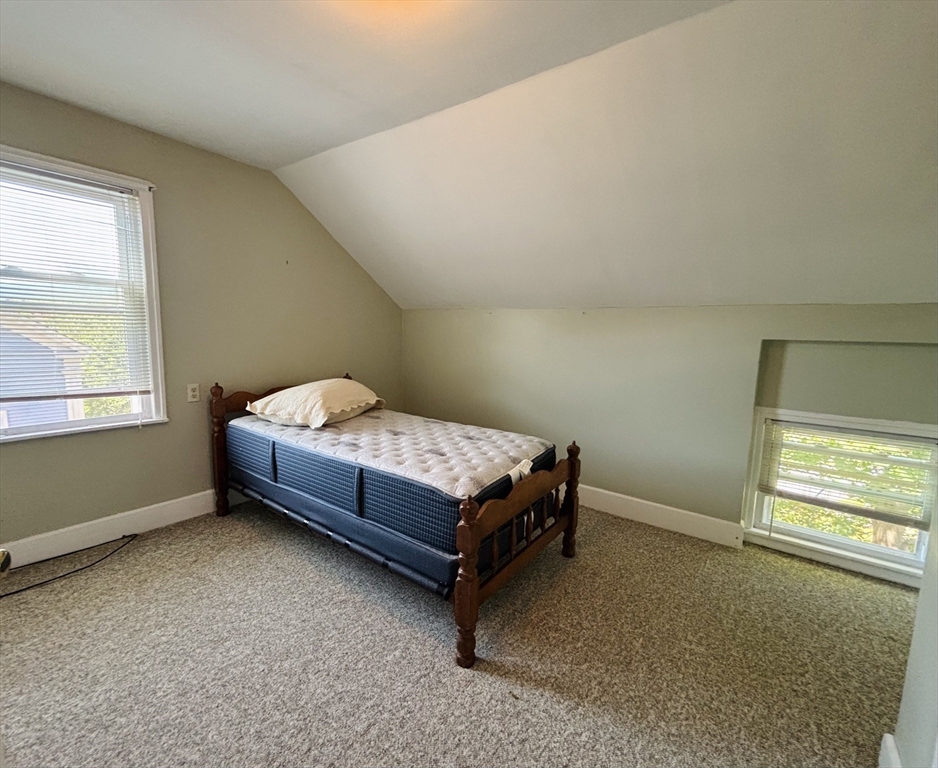 27 Fletcher Street, Unit 1 Northbridge, MA 01588 - Photo 9 of 12 a bedroom with a bed and window