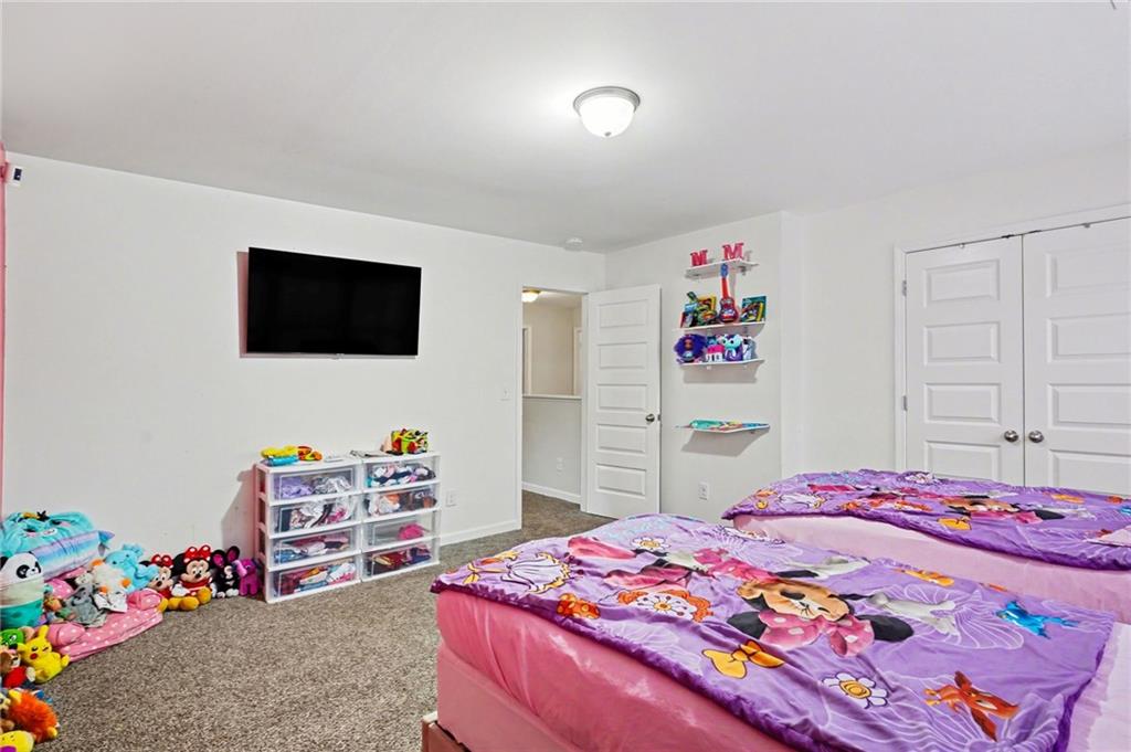 1241 England Terrace Hampton, GA 30228 - Photo 18 of 20 a bedroom with a bed and a flat screen tv
