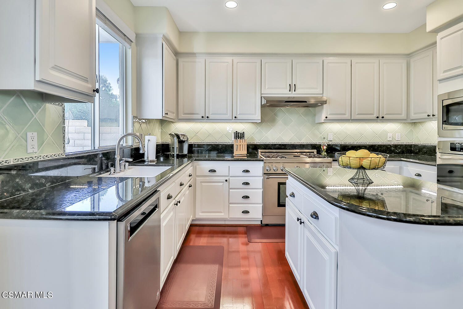 4904 Promenade Street Simi Valley, CA 93063 - Photo 22 of 63 a kitchen with granite countertop a sink stove and cabinets