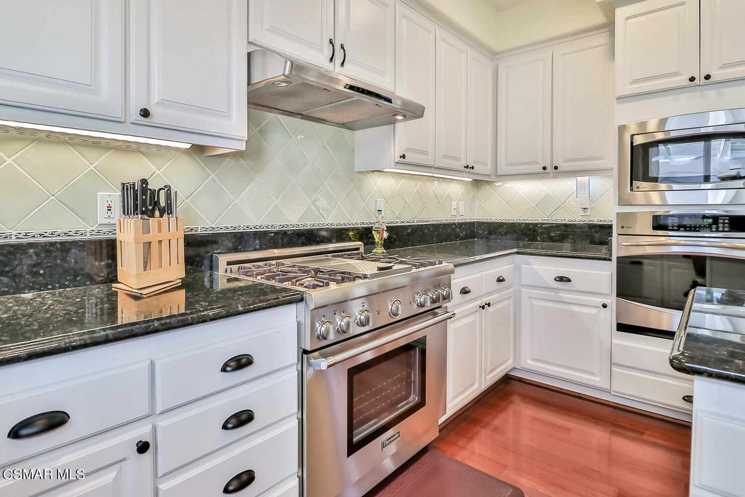 4904 Promenade Street Simi Valley, CA 93063 - Photo 24 of 63 a kitchen with stainless steel appliances granite countertop a sink and a stove