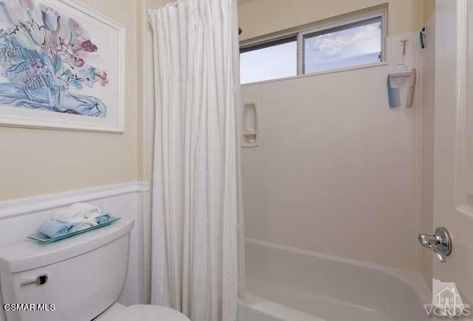 4904 Promenade Street Simi Valley, CA 93063 - Photo 47 of 63 a bathroom with a granite countertop sink a toilet and a shower curtain