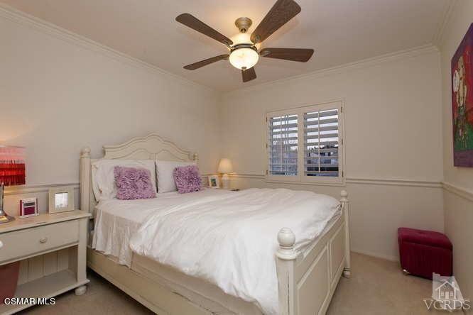 4904 Promenade Street Simi Valley, CA 93063 - Photo 48 of 63 a bedroom with a bed and a chandelier