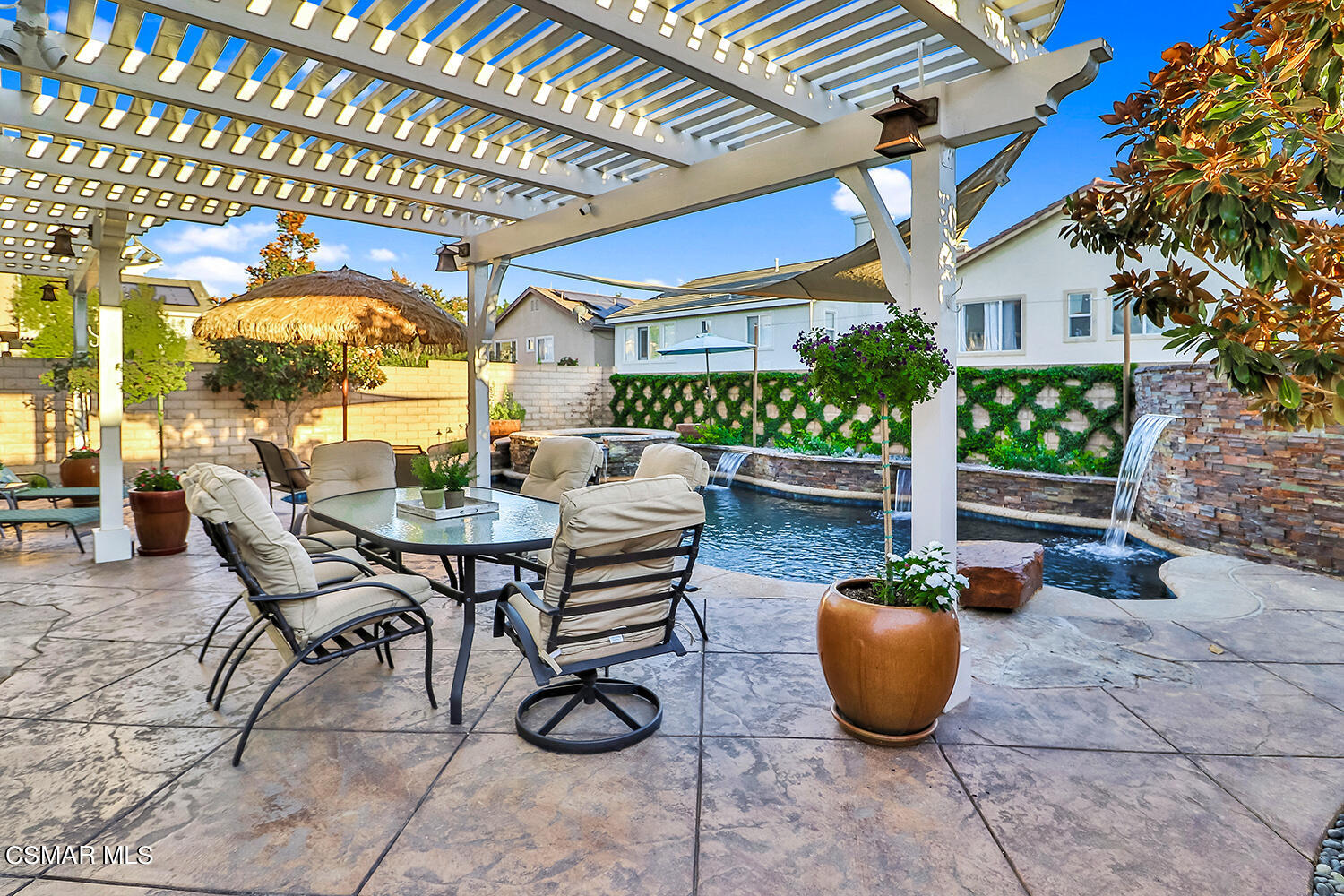 4904 Promenade Street Simi Valley, CA 93063 - Photo 51 of 63 a view of a patio with a dining table and chairs under an umbrella