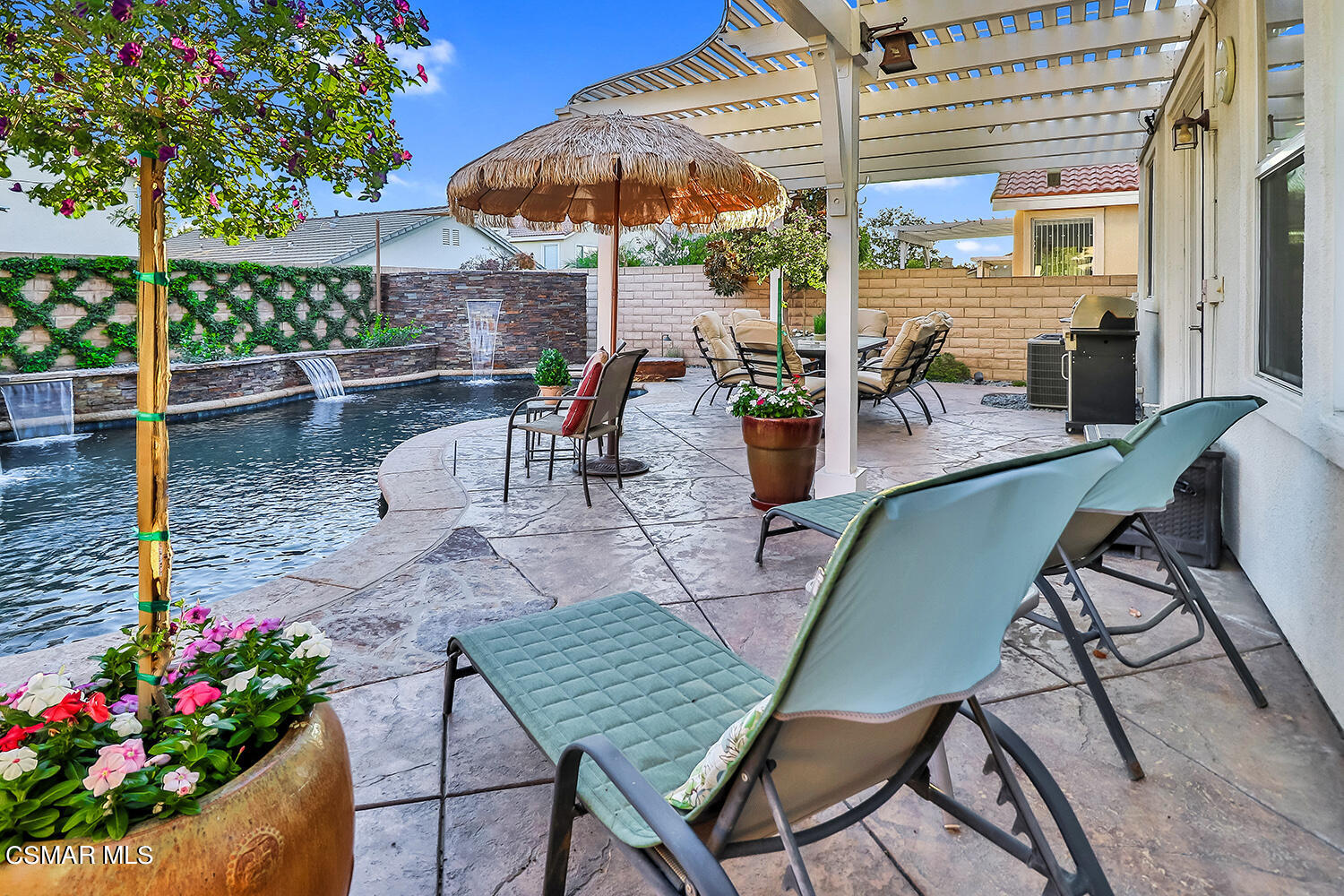 4904 Promenade Street Simi Valley, CA 93063 - Photo 53 of 63 a view of a patio with a table and chairs under an umbrella