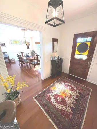 a view of an entryway with wooden floor