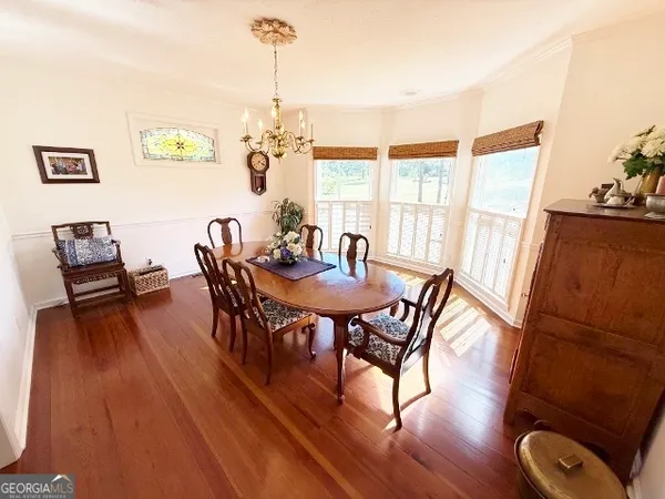 a view of a dining room with furniture window and wooden floor