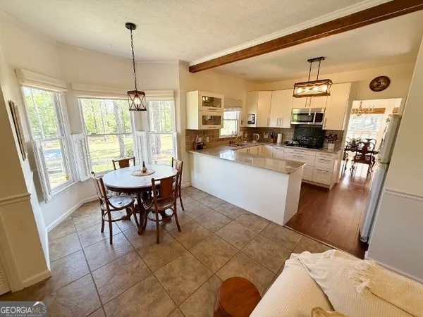 a kitchen with stainless steel appliances granite countertop a sink a stove top oven a counter space and cabinets