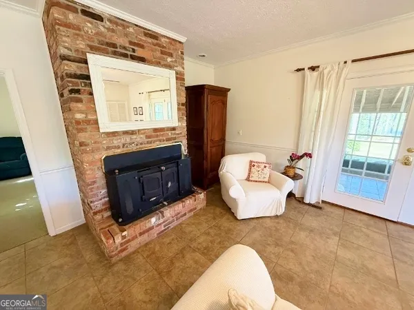 a bedroom with a bed fireplace and a window