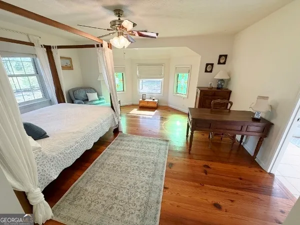 a bedroom with a bed window and couch