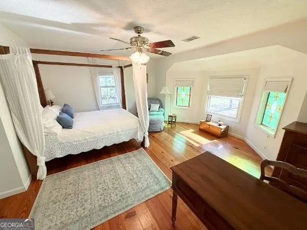 a bedroom with two beds and painting on the wall