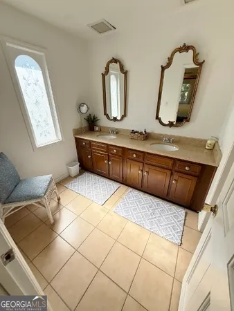 a bathroom with a sink a vanity and mirror