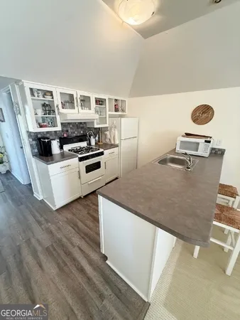 a view of kitchen with sink and wooden floor