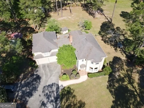an aerial view of a house with a yard and garden