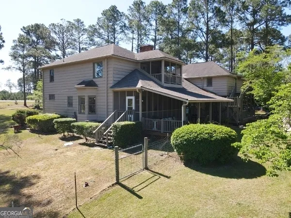 a view of a house with a yard and sitting area