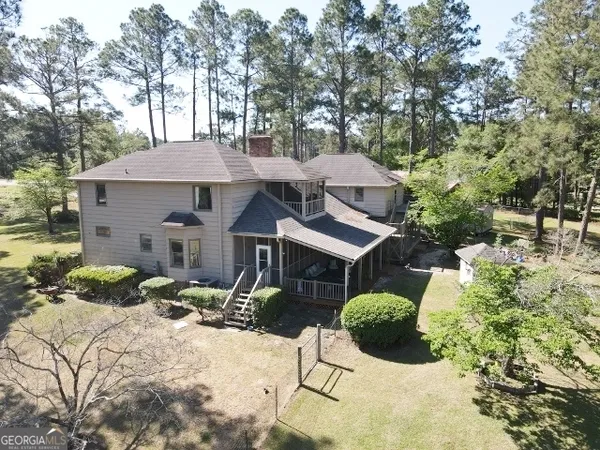 a front view of a house with yard and trees