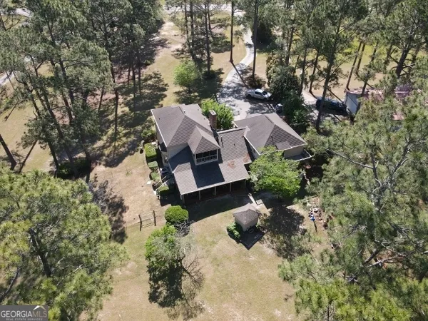 an aerial view of a house with a yard