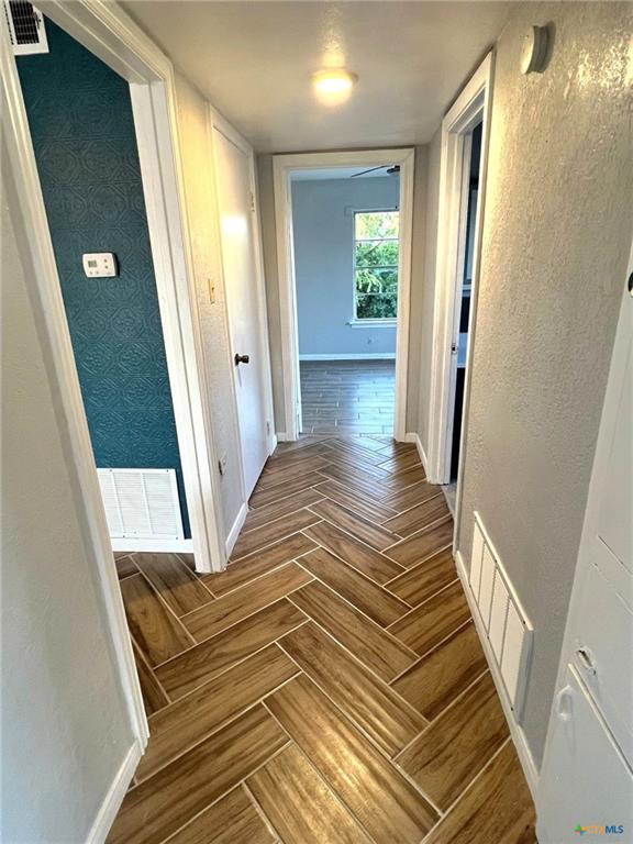 805 Sissom Road Killeen, TX 76541 - Photo 15 of 35 Hallway with a textured wall and parquet flooring