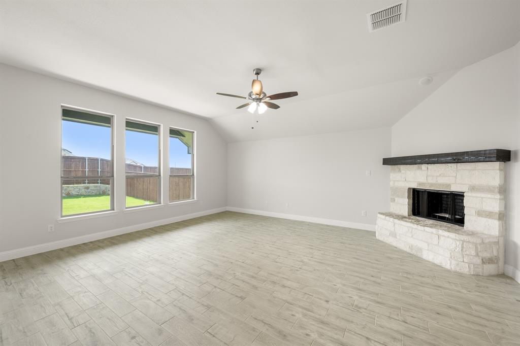 228 Shepards Street Godley, TX 76044 - Photo 16 of 27 a view of an empty room with a fireplace and a window