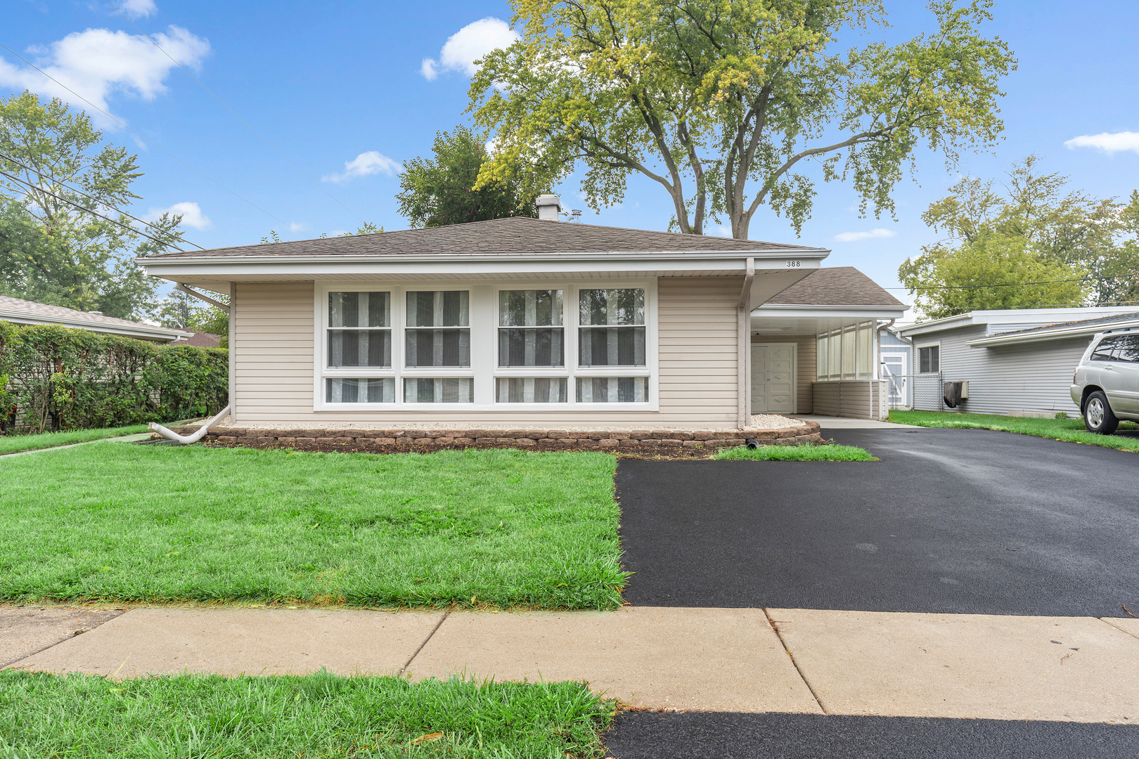 388 Nancy Lane Wheeling, IL 60090 - Photo 1 of 22 a front view of a house with a garden