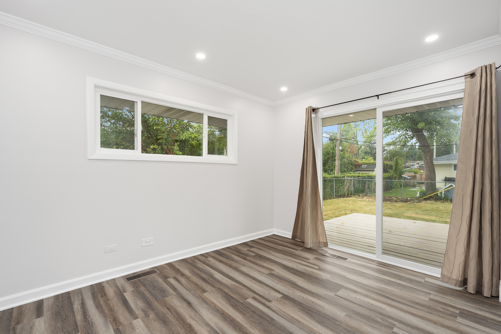 388 Nancy Lane Wheeling, IL 60090 - Photo 12 of 22 a view of an empty room with wooden floor and a window