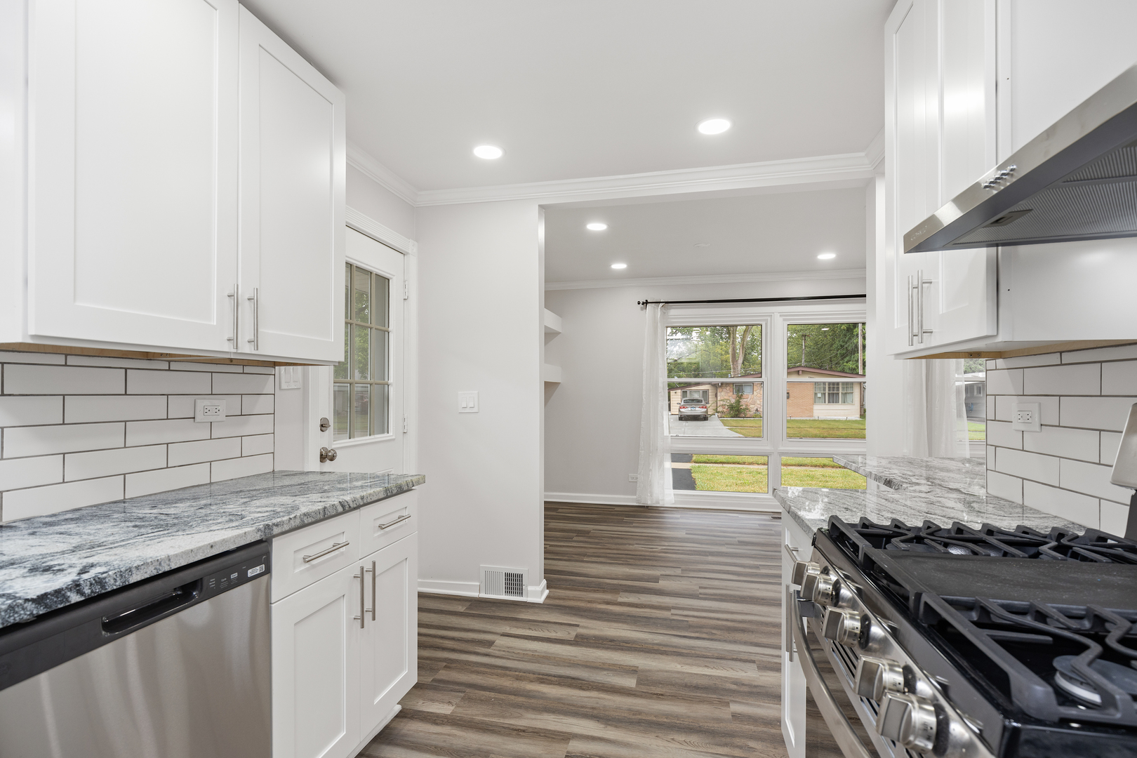 388 Nancy Lane Wheeling, IL 60090 - Photo 7 of 22 a kitchen with granite countertop a stove and a sink