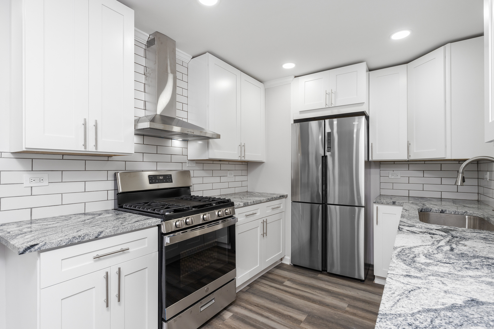 388 Nancy Lane Wheeling, IL 60090 - Photo 8 of 22 a kitchen with stainless steel appliances granite countertop a stove a refrigerator and a refrigerator