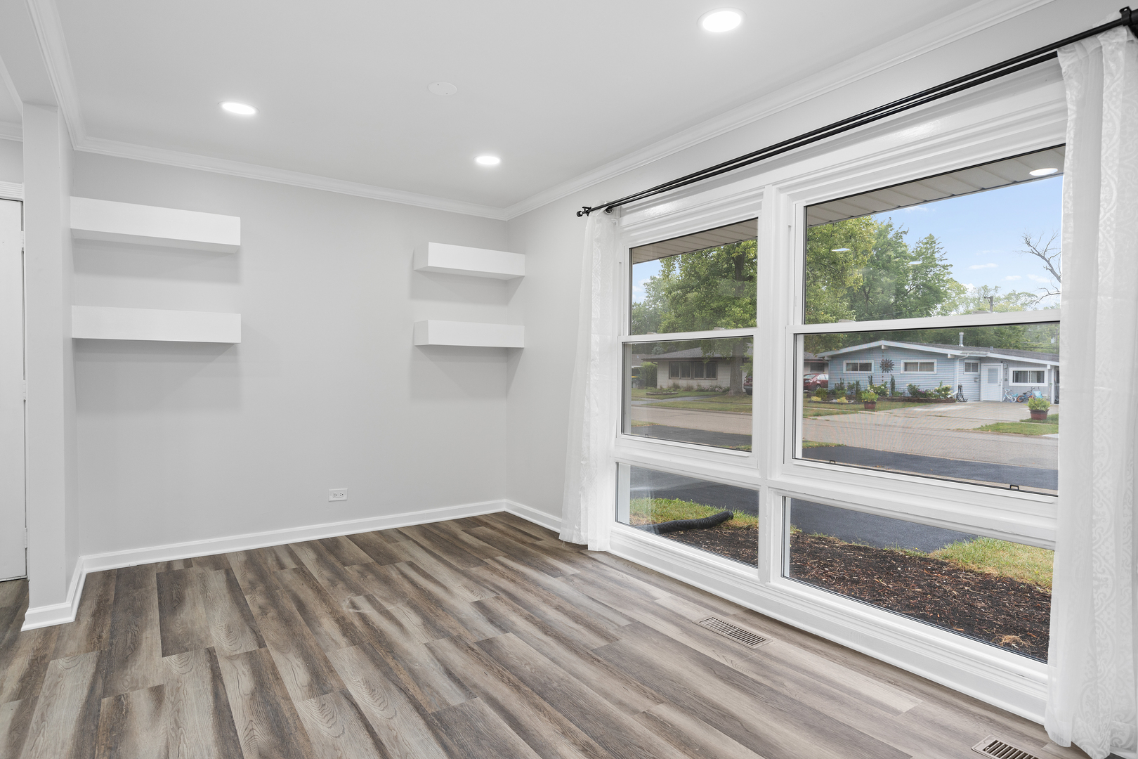 388 Nancy Lane Wheeling, IL 60090 - Photo 9 of 22 a view of a room with wooden floor and windows