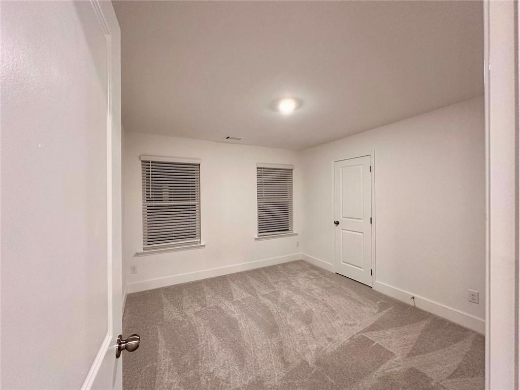 537 Hyde Rdg Trail Loganville, GA 30052 - Photo 11 of 23 an empty room with windows