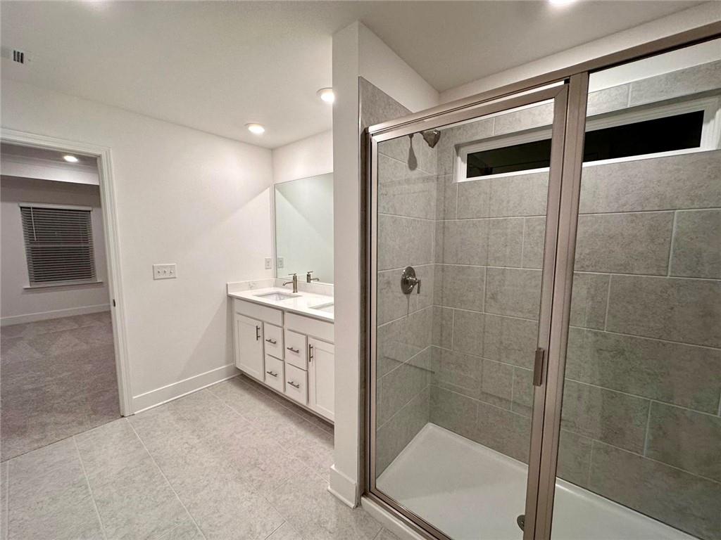 537 Hyde Rdg Trail Loganville, GA 30052 - Photo 13 of 23 a bathroom with a shower sink and mirror