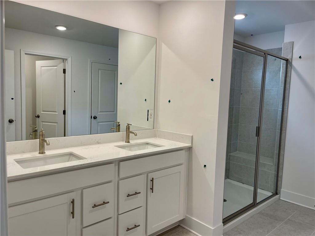 537 Hyde Rdg Trail Loganville, GA 30052 - Photo 18 of 23 a bathroom with a sink and a mirror